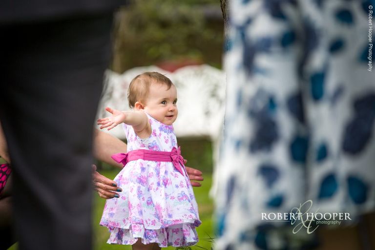 Toddler walking on her own on the lawn during Oaks Farm wedding Shirley Surrey