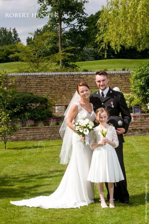 Bride, groom and their daughter who was flower girl on their wedding day at Oaks Farm Barn Shirley Surrey
