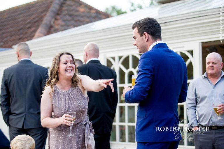 Wedding guests enjoying drinks at reception at Oaks Farm Barn Shirley Surrey