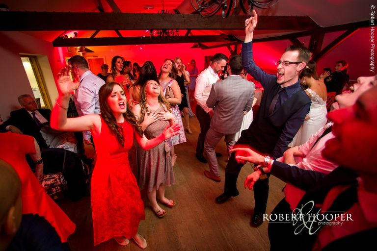 Evening wedding guests dancing after first dance at Oaks Farm Barn Surrey