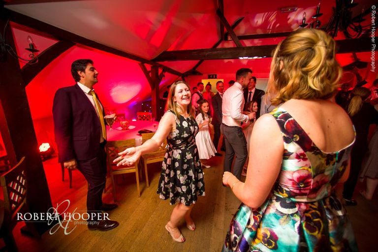 Evening wedding guests dancing after first dance at Oaks Farm Barn Surrey