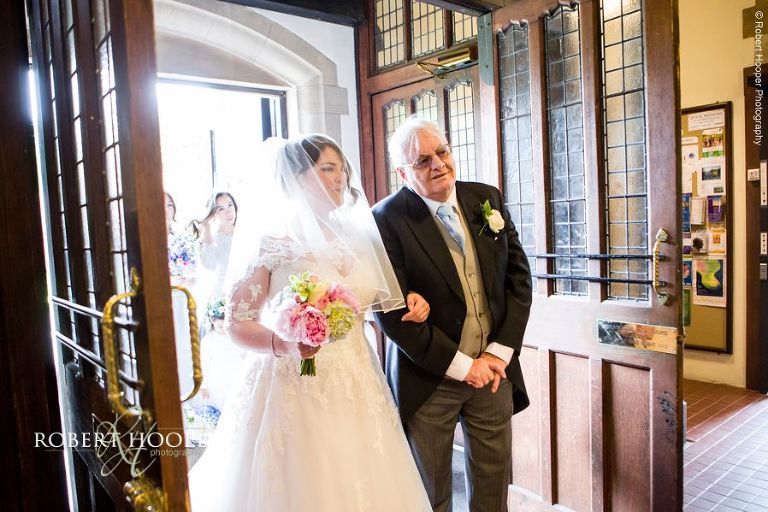 Bride preparing to walk down the isle with her dad at Sacred Heart Church Wimbledon