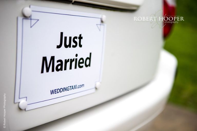 "Just Married" sign on back of wedding taxi taking bride and groom to their wedding reception at Hampton Court House Surrey