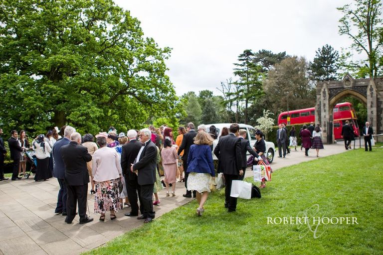 Wedding guests outside Sacred Heart Church Wimbledon London after wedding ceremony