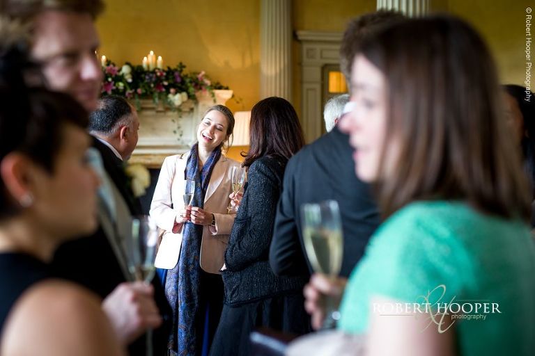 Wedding guests enjoying champagne and canapes at Hampton Court House Surrey