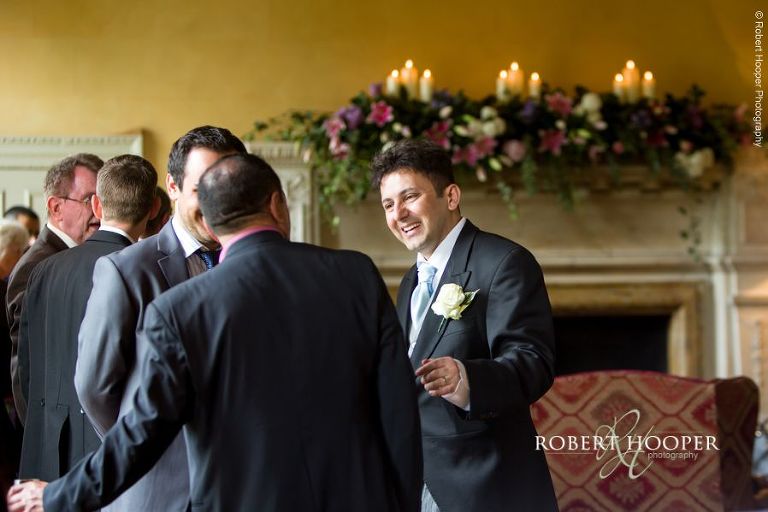 Bride groom chatting to guests at wedding reception at Hampton Court House Surrey