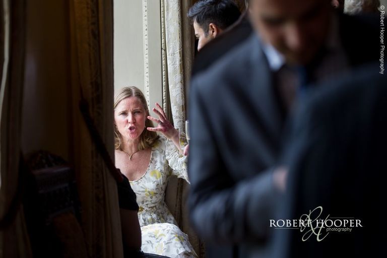 Wedding guests chatting during drinks reception at Hampton Court House Surrey