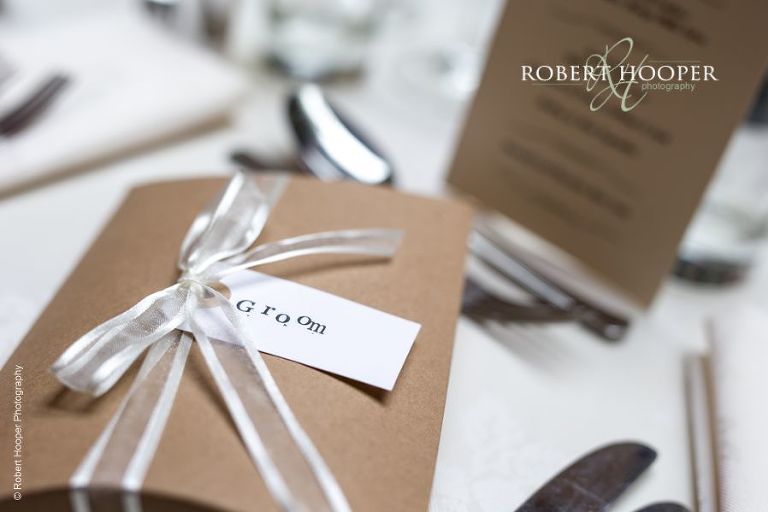 Name tags on gifts on top table for wedding breakfast at Hampton Court House Surrey