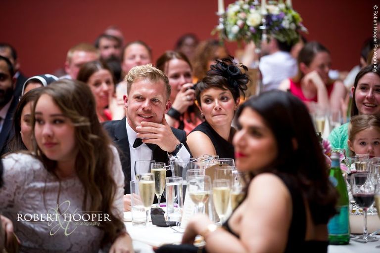 Wedding guests during speeches at wedding breakfast at Hampton Court House Surrey