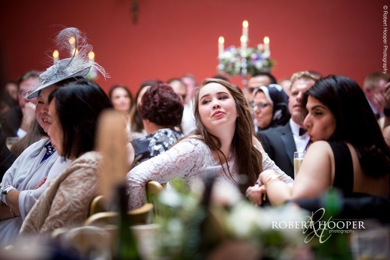 Wedding guests during speeches at wedding reception at Hampton Court House Surrey