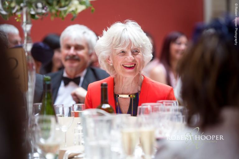 Wedding guests during speeches at wedding reception at Hampton Court House Surrey