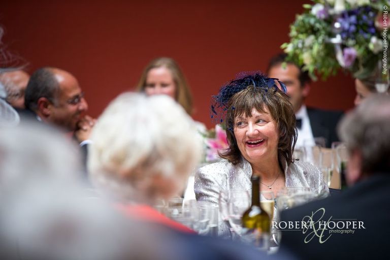 Wedding guests during speeches at wedding reception at Hampton Court House Surrey