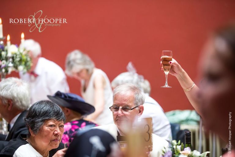 Toasts during wedding reception at Hampton Court House Surrey