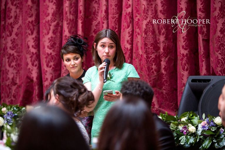 Bride's friends make a speech at wedding breakfast at Hampton Court House Surrey