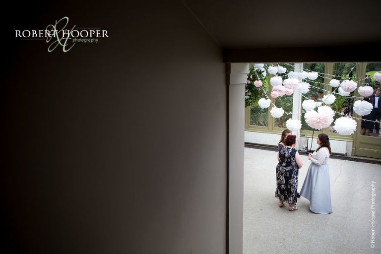 Bridesmaid and guests chatting at wedding reception at Hampton Court House Surrey