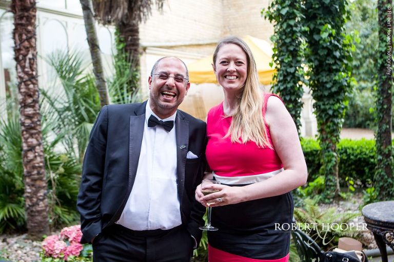 Guests smile for the camera at wedding reception at Hampton Court House Surrey
