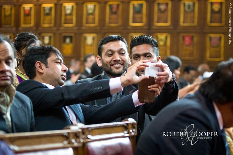 Wedding guests take photos of couple during Hindu ceremony at Middle Temple London