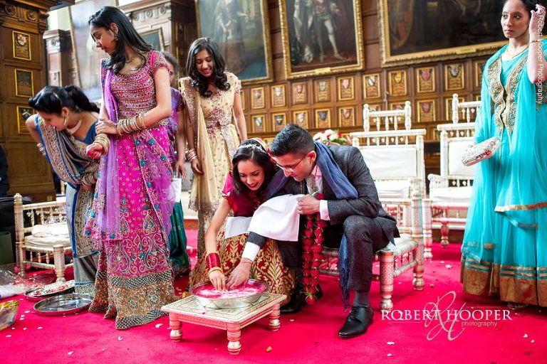 Bride and groom fish for wedding rings during Hindu ceremony at Middle Temple London
