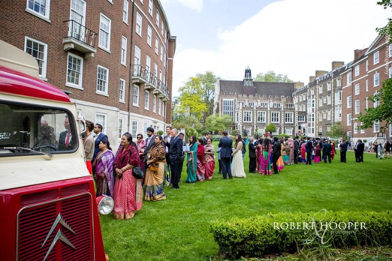 Wedding guests being served food from Pizza van at Hindu wedding at Middle Temple London