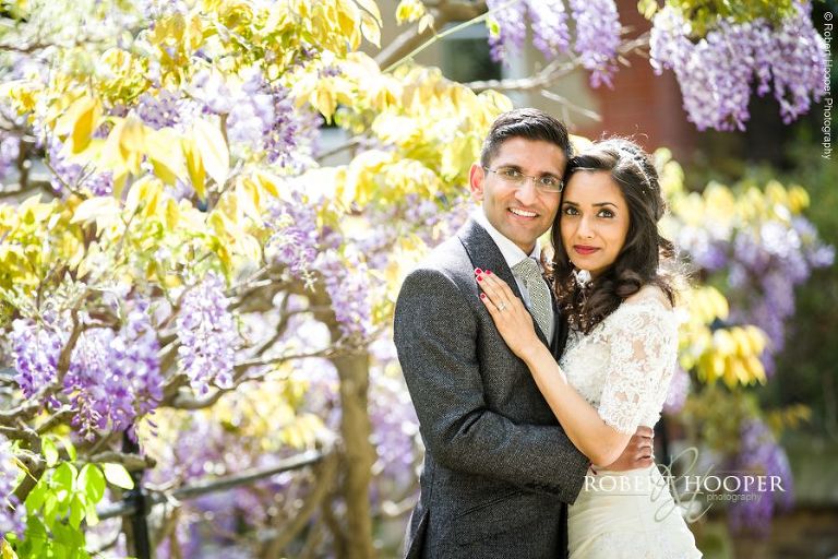 Bride and groom amid Wisteria after wedding at Middle Temple London