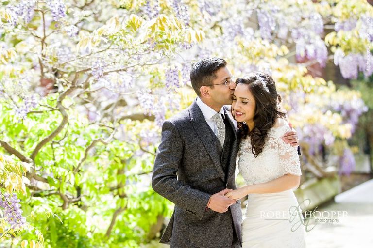 Bride and groom walking by Wisteria after wedding at Middle Temple London