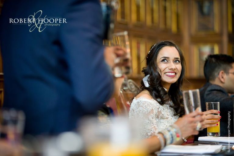 Bride smiling at speech by father of the bride after wedding at Middle Temple London