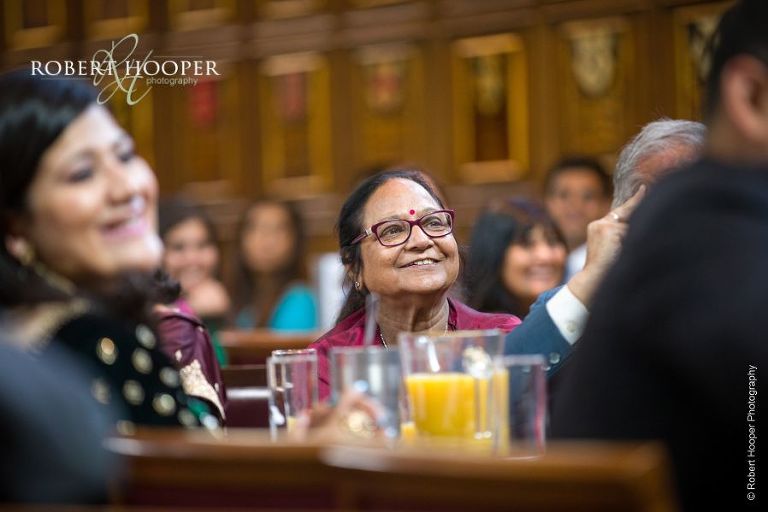 Wedding guests enjoying speeches at wedding celebration Middle Temple London