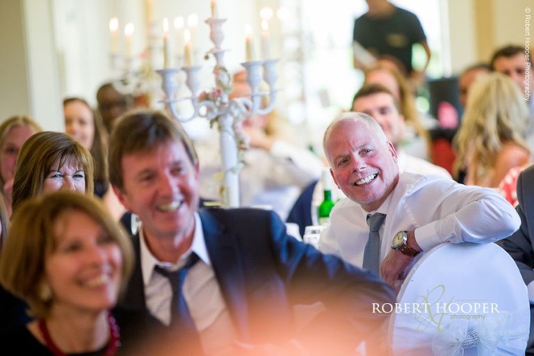 Wedding guests during speeches at reception Woldingham Golf Club Surrey
