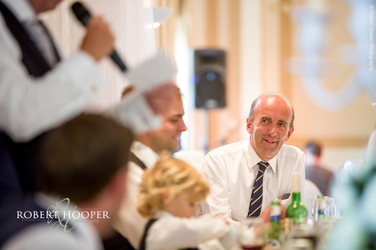 Wedding guests during speeches at reception Woldingham Golf Club Surrey