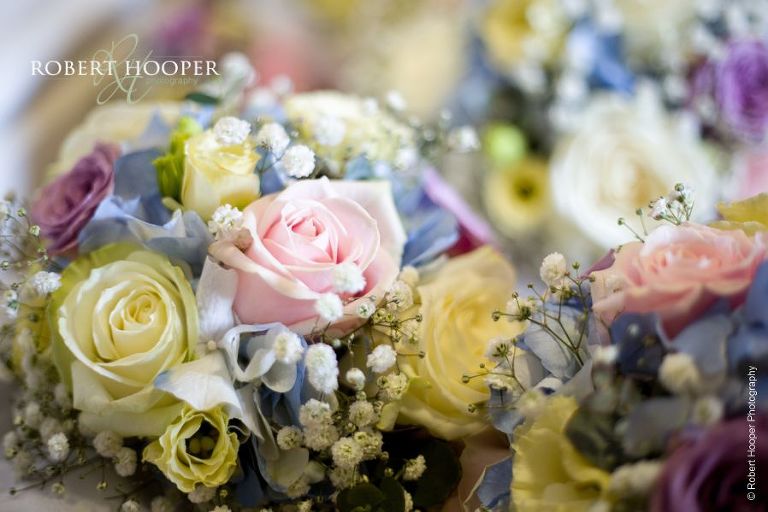 Bride's bouquet of pink, yellow and dusty pink roses for wedding day at Wotton House Dorking Surrey