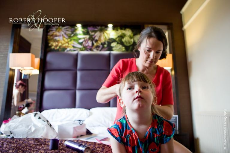 Flower girl having hair done for wedding at Wotton House Dorking Surrey