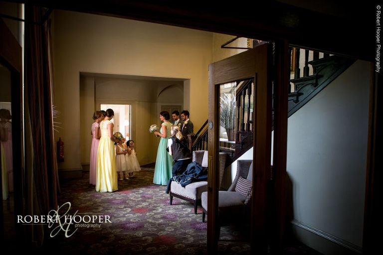 Bridal party assembled outside ceremony room on wedding day at Wotton House Surrey