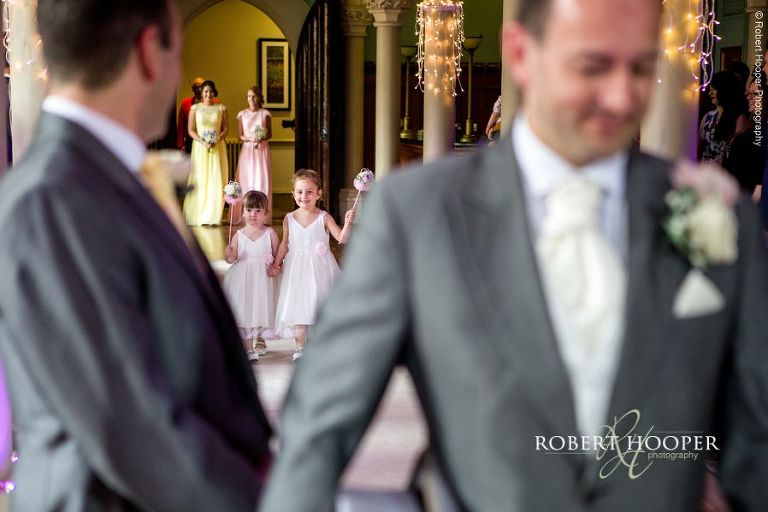 Cute flower girls walking down the isle of wedding day at Wotton House Dorking Surrey