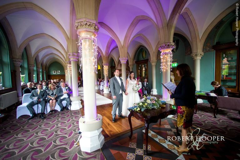 Bride and groom during civil wedding ceremony in Old Library at Wotton House Dorking Surrey