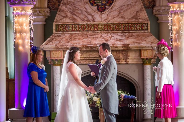 Bride and groom during civil wedding ceremony in Old Library at Wotton House Dorking Surrey