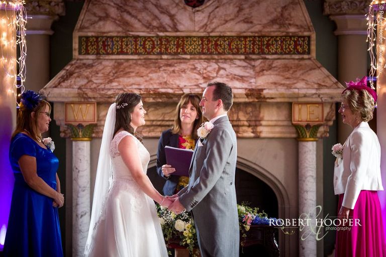 Bride and groom during civil wedding ceremony in Old Library at Wotton House Dorking Surrey