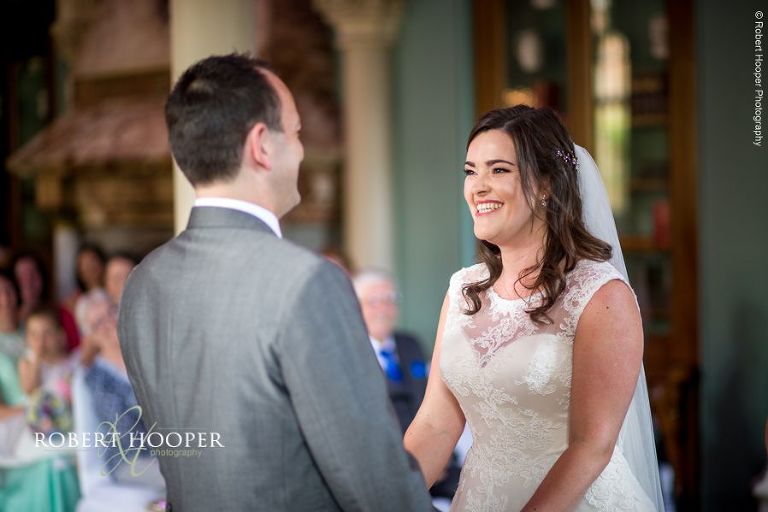 Bride and groom during civil wedding ceremony in Old Library at Wotton House Dorking Surrey