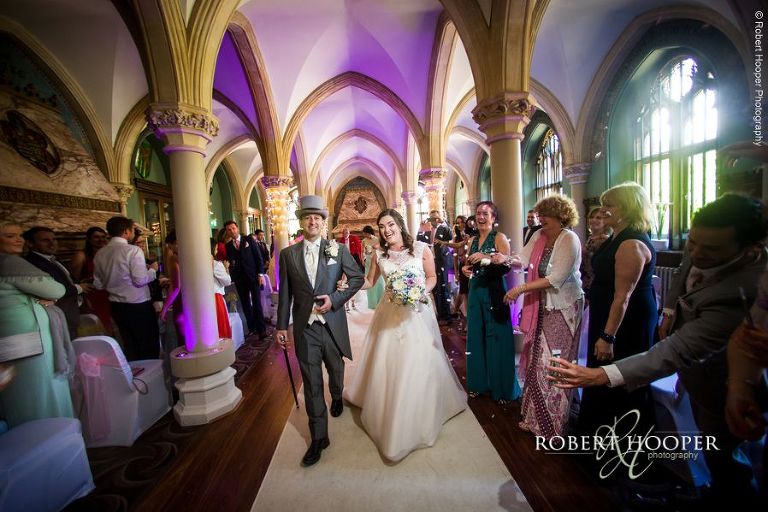 Bride and groom walk back up the isle as man and wife after civil wedding ceremony in Old Library at Wotton House Dorking Surrey