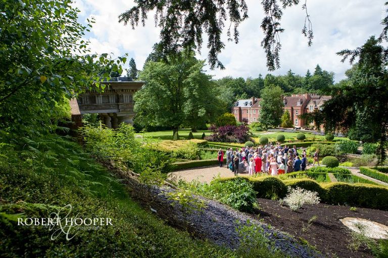 View of guests in gardens on wedding day at Wotton House Surrey