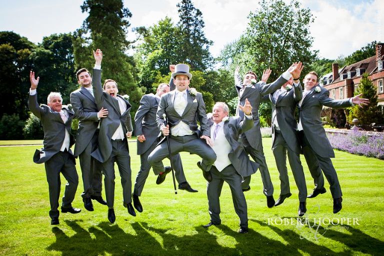 Groomsmen larking around on wedding day at Wotton House wedding Surrey