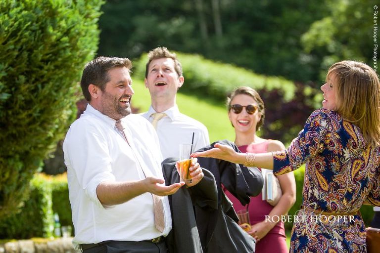Wedding guests enjoying champagne at wedding reception at Wotton House Dorking Surrey