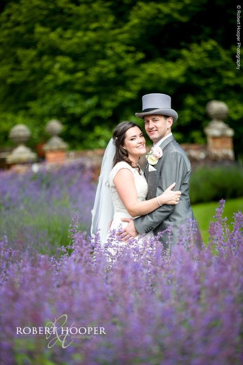 Bride and groom amongst purple lavender on wedding day at Wotton House Dorking Surrey