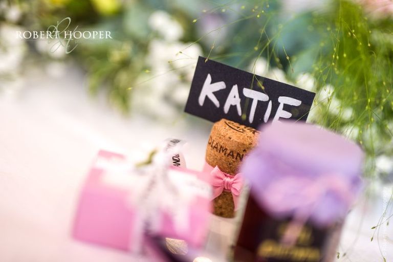 Place cards in champagne corks on tables for wedding breakfast at Wotton House Dorking Surrey