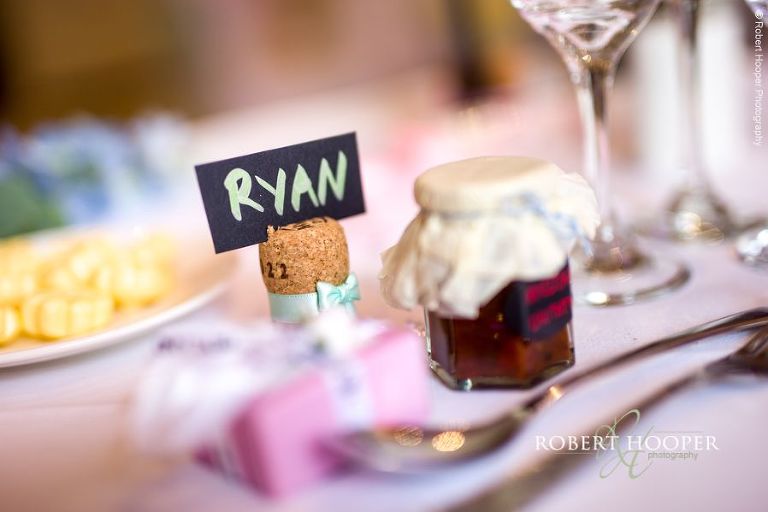 Place cards in champagne corks on tables for wedding breakfast at Wotton House Dorking Surrey