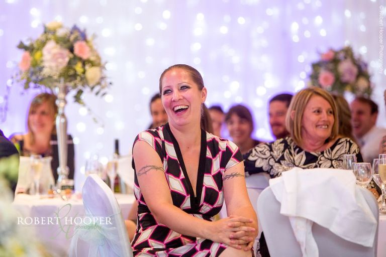Wedding guests laughing at best man's speech at Wotton House Dorking Surrey
