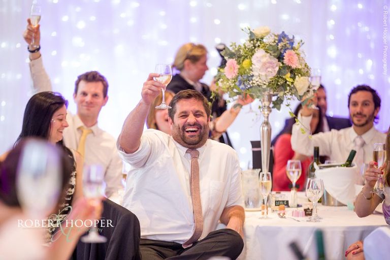 Wedding guests laughing at best man's speech at Wotton House Dorking Surrey