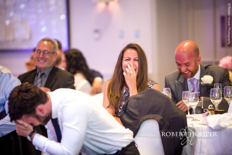 Wedding guests laughing at best man's speech at Wotton House Dorking Surrey