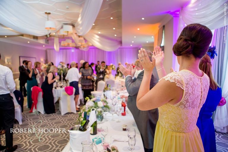 Wedding guests clapping speeches at wedding breakfast at Wotton House Dorking Surrey