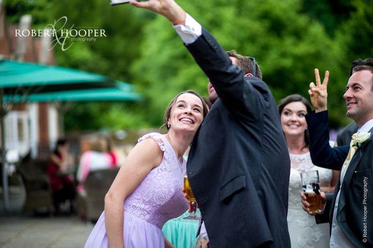 Wedding guests taking selfies on wedding day at Wotton House Dorking Surrey