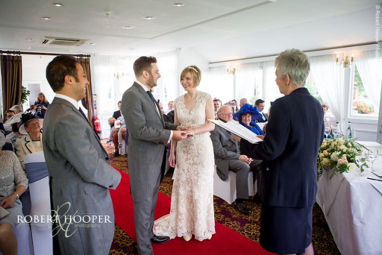 Bride and groom during civil ceremony in orangery at Chilston Park Hotel Miadstone Kent